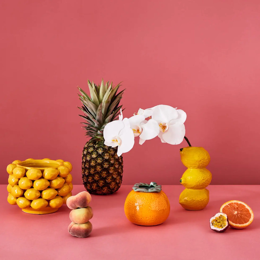 Styled photo of fruit themed ceramic vases and homewares styled with fresh fruit